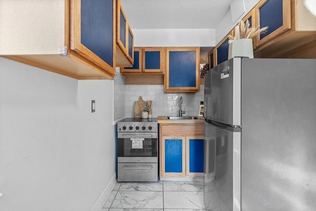 kitchen with sink, backsplash, and stainless steel appliances