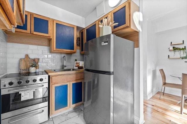 kitchen featuring sink, appliances with stainless steel finishes, and tasteful backsplash