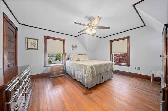 bedroom with baseboards, ceiling fan, lofted ceiling, and hardwood / wood-style floors