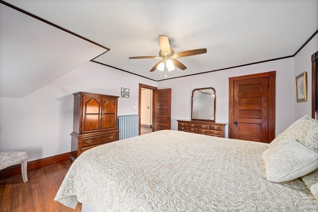 bedroom featuring baseboards, ornamental molding, a ceiling fan, and dark wood-type flooring