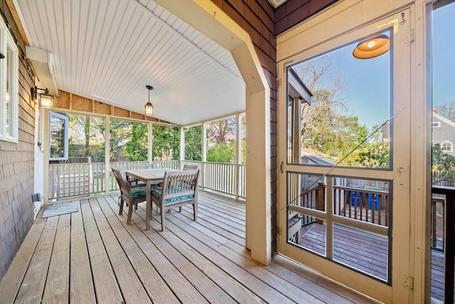 sunroom / solarium with plenty of natural light and outdoor dining space