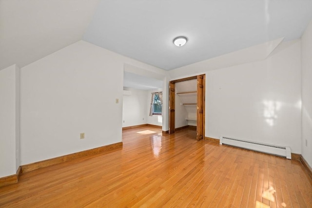 bonus room with baseboards, a baseboard radiator, light wood finished floors, and vaulted ceiling
