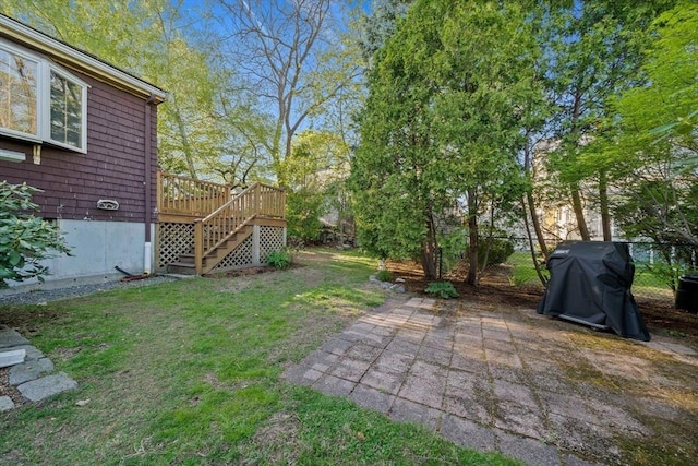 view of yard with a deck, a patio area, and stairway