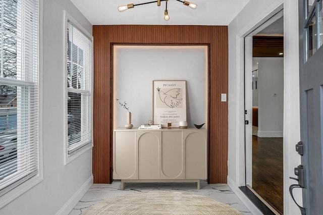 interior space with marble finish floor and baseboards