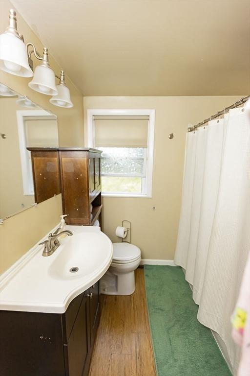 24 Curve St, Brockton, MA 02302 - bathroom featuring vanity, wood finished floors, and a shower with curtain