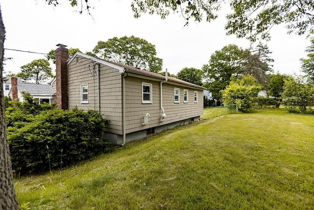 24 Curve St, Brockton, MA 02302 - view of side of home featuring a yard and a chimney