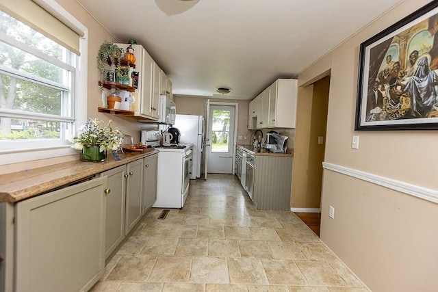 24 Curve St, Brockton, MA 02302 - kitchen with white appliances, stone finish flooring, open shelves, and white cabinetry
