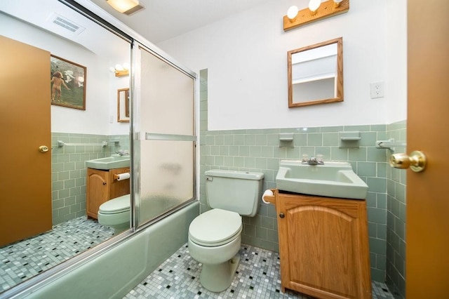 35 Lazywood Ln, Swansea, MA 02777 - bathroom featuring tile walls, tile patterned flooring, wainscoting, vanity, and shower / bath combination with glass door