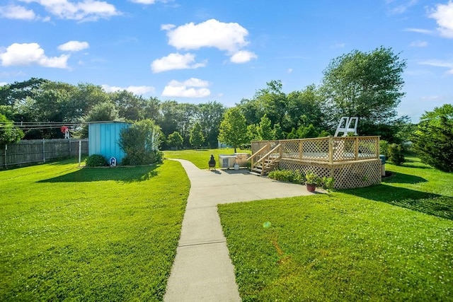35 Lazywood Ln, Swansea, MA 02777 - view of yard featuring a deck, a patio, and view of wooded area
