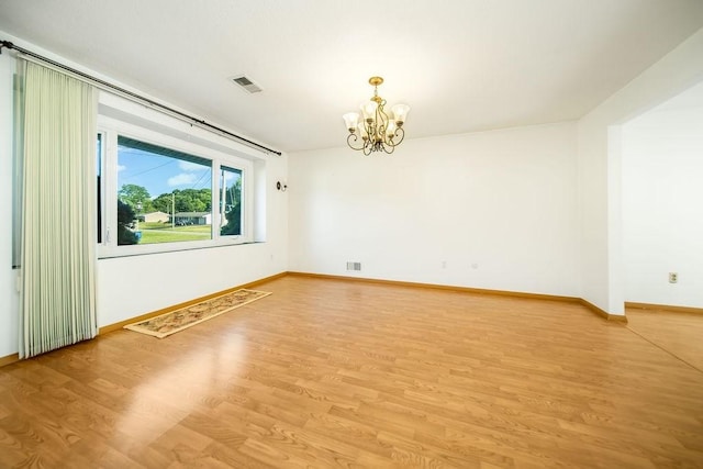 35 Lazywood Ln, Swansea, MA 02777 - spare room featuring a chandelier and light wood-style flooring
