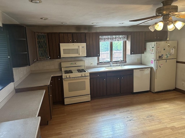 54 Brunswick Park, Melrose, MA 02176 - kitchen with white appliances, light countertops, light wood-style flooring, and dark brown cabinetry