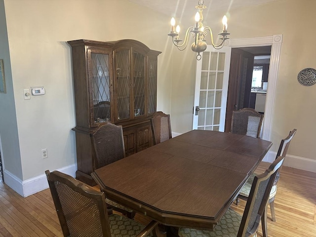 54 Brunswick Park, Melrose, MA 02176 - dining area featuring a chandelier, baseboards, and wood-type flooring