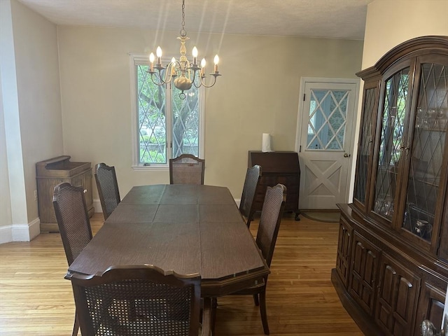 54 Brunswick Park, Melrose, MA 02176 - dining area featuring a chandelier, light wood-style floors, and baseboards
