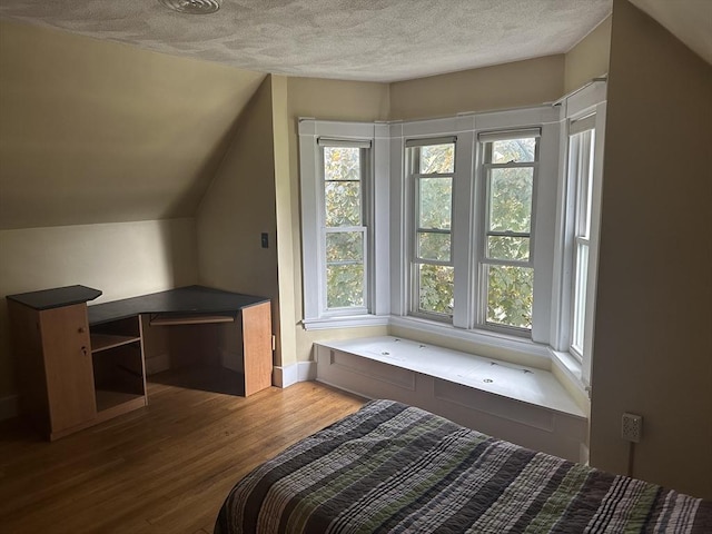 54 Brunswick Park, Melrose, MA 02176 - bedroom featuring wood finished floors, a textured ceiling, lofted ceiling, and baseboards