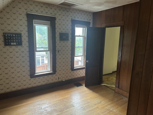54 Brunswick Park, Melrose, MA 02176 - empty room with light wood-style floors, plenty of natural light, and wallpapered walls