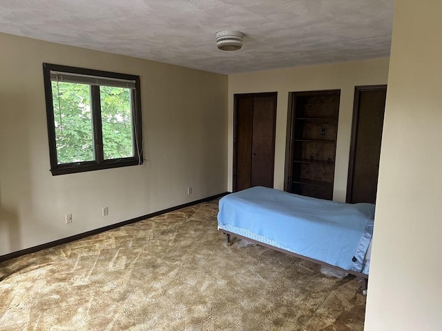 54 Brunswick Park, Melrose, MA 02176 - bedroom featuring baseboards, carpet, a textured ceiling, and multiple closets