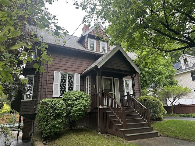 54 Brunswick Park, Melrose, MA 02176 - view of front of property featuring a chimney, fence, and a shingled roof