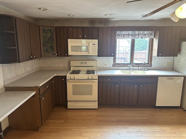 54 Brunswick Park, Melrose, MA 02176 - kitchen featuring white appliances, a sink, dark brown cabinets, light countertops, and light wood-style flooring