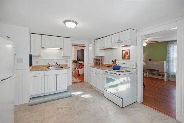 kitchen featuring sink, white cabinets, white appliances, ceiling fan, and light hardwood / wood-style flooring