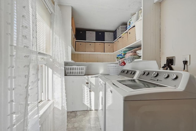 clothes washing area featuring independent washer and dryer