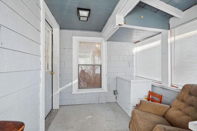 interior space with lofted ceiling and concrete floors