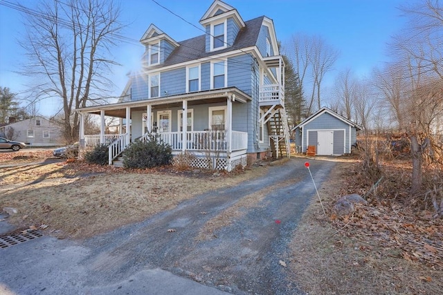 view of front of house featuring a porch and a shed