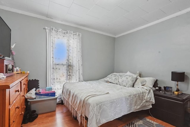 bedroom featuring hardwood / wood-style floors and ornamental molding