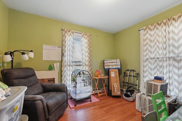 sitting room featuring hardwood / wood-style floors and a baseboard radiator