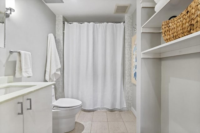 bathroom with curtained shower, tile patterned floors, vanity, and toilet