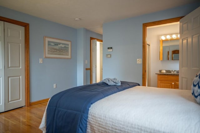 bedroom with wood finished floors and baseboards