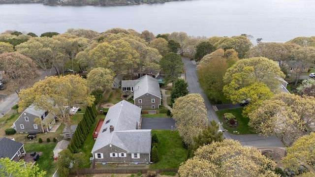 aerial view of property and surrounding area featuring a large body of water and nearby suburban area