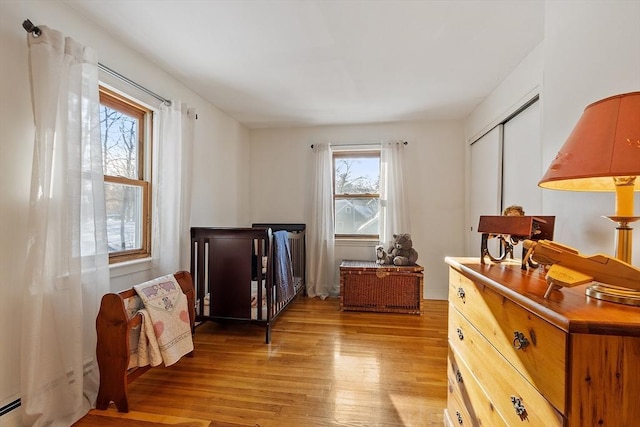 bedroom featuring light hardwood / wood-style flooring and a closet