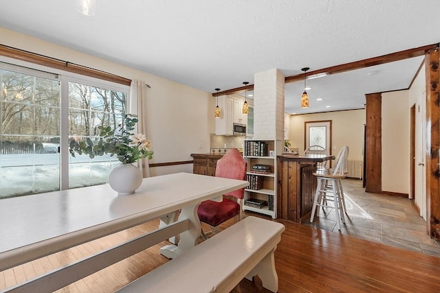 dining room featuring light hardwood / wood-style floors and radiator