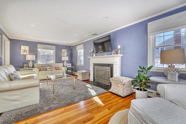 living room with hardwood / wood-style floors and ornamental molding