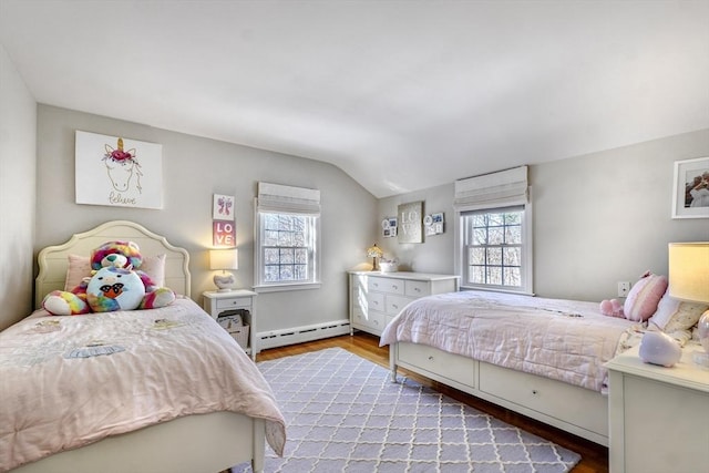 bedroom with lofted ceiling, multiple windows, light hardwood / wood-style floors, and baseboard heating