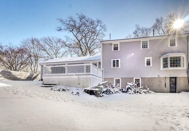 view of snow covered back of property