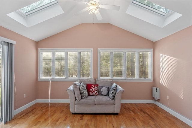 sitting room featuring ceiling fan, light hardwood / wood-style floors, and vaulted ceiling