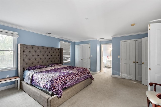 bedroom featuring ensuite bathroom, light colored carpet, and ornamental molding