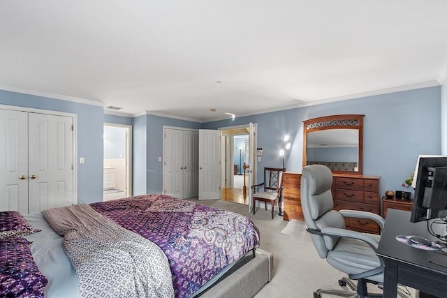 carpeted bedroom with crown molding and two closets