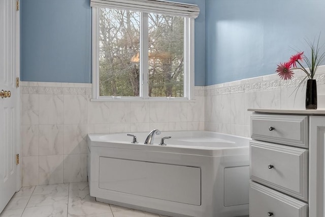 bathroom featuring plenty of natural light and tile walls