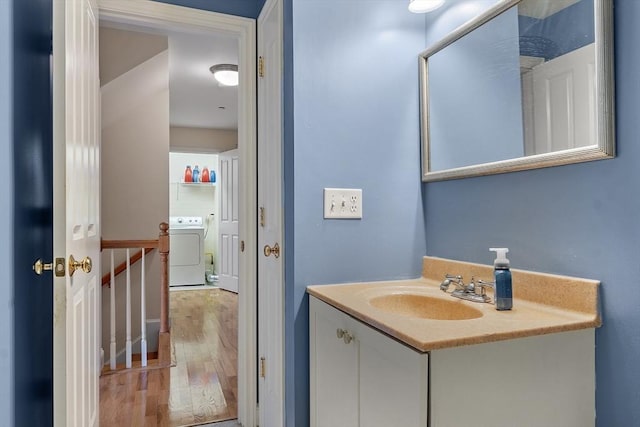 bathroom with vanity, wood-type flooring, and washer / clothes dryer