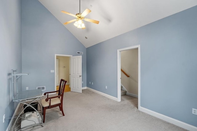 carpeted office with ceiling fan and high vaulted ceiling