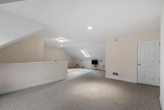 bonus room with lofted ceiling with skylight and carpet floors