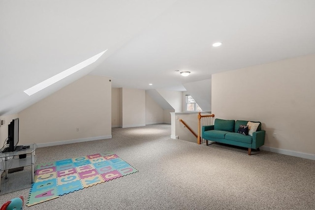 bonus room featuring lofted ceiling with skylight and light carpet