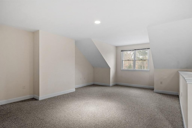 bonus room featuring carpet and vaulted ceiling