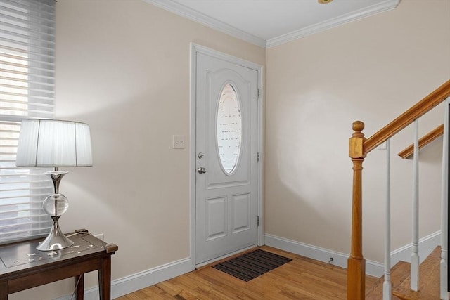 entryway with light hardwood / wood-style floors and ornamental molding