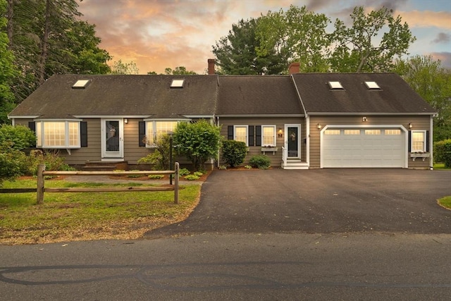 14 Prince St, Danvers, MA 01923 - view of front of house featuring driveway, a garage, and a chimney