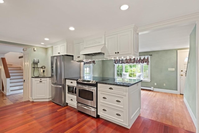 14 Prince St, Danvers, MA 01923 - kitchen featuring custom range hood, appliances with stainless steel finishes, dark wood finished floors, white cabinetry, and a baseboard heating unit