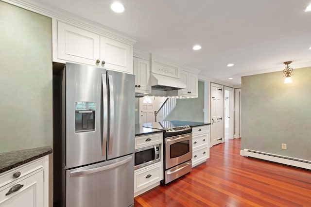 14 Prince St, Danvers, MA 01923 - kitchen with appliances with stainless steel finishes, premium range hood, dark wood-style flooring, white cabinets, and a baseboard heating unit