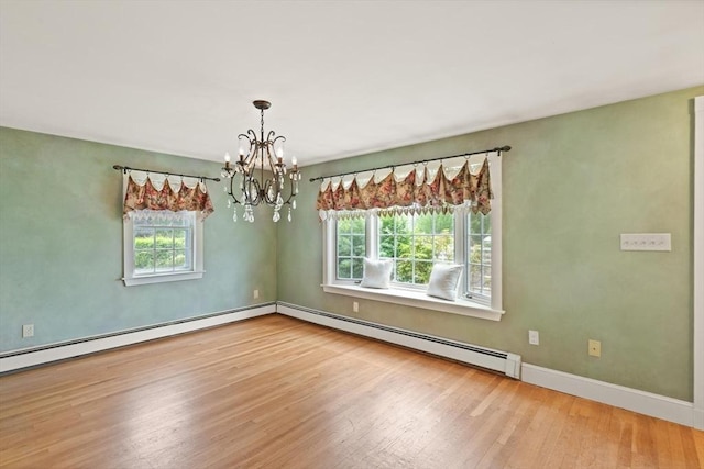 14 Prince St, Danvers, MA 01923 - spare room with healthy amount of natural light, baseboard heating, a chandelier, and wood finished floors